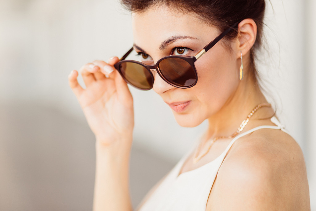 Portrait of business woman in sunglasses and leather skirt